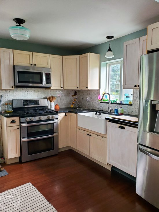 This boring kitchen with off white cabinets is going to be updated into a modern kitchen with vintage touches.