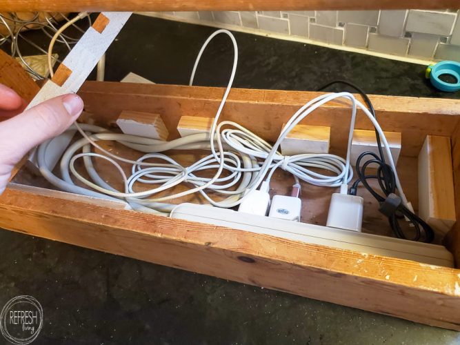 This is genius! Hide all the electronics charging cords in a tool crate and top it with wood. This is pretty enough to leave out on the counter, and all of the clutter is hidden. Great organization idea!
