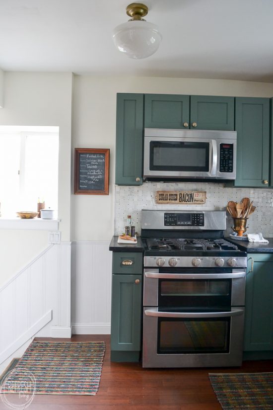 kitchen with green soapstone counters, and marble backsplash