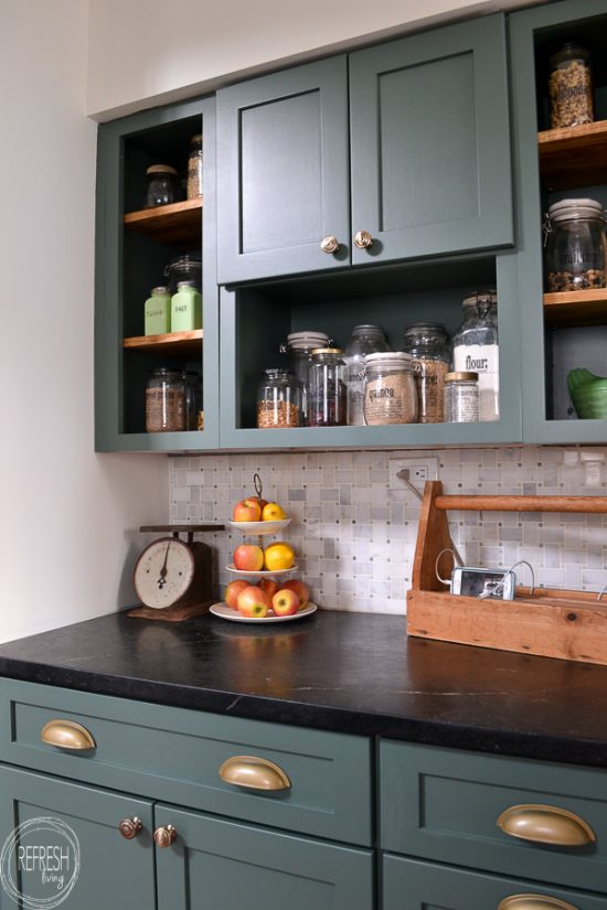 This budget friendly kitchen makeover is perfect with green cabinets, soapstone counters, and a marble backsplash. A perfect mix of modern and vintage touches creates a beautiful space.