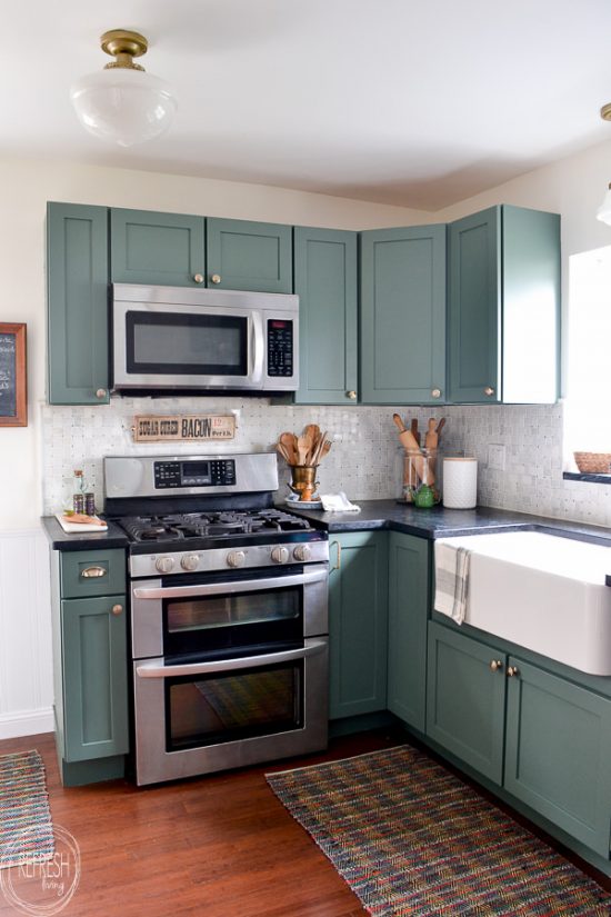 This budget friendly kitchen makeover is perfect with green cabinets, soapstone counters, and a marble backsplash. A perfect mix of modern and vintage touches creates a beautiful space.