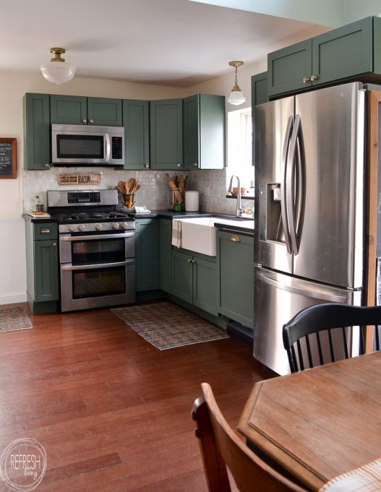 This budget friendly kitchen makeover is perfect with green cabinets, soapstone counters, and a marble backsplash. A perfect mix of modern and vintage touches creates a beautiful space.