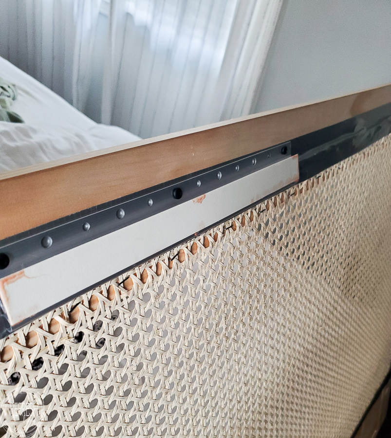 The best way to hang a headboard on the wall. This lipstick trick is the best way to hang things level without measuring. How to make a DIY headboard with caning for a modern look on a small budget!