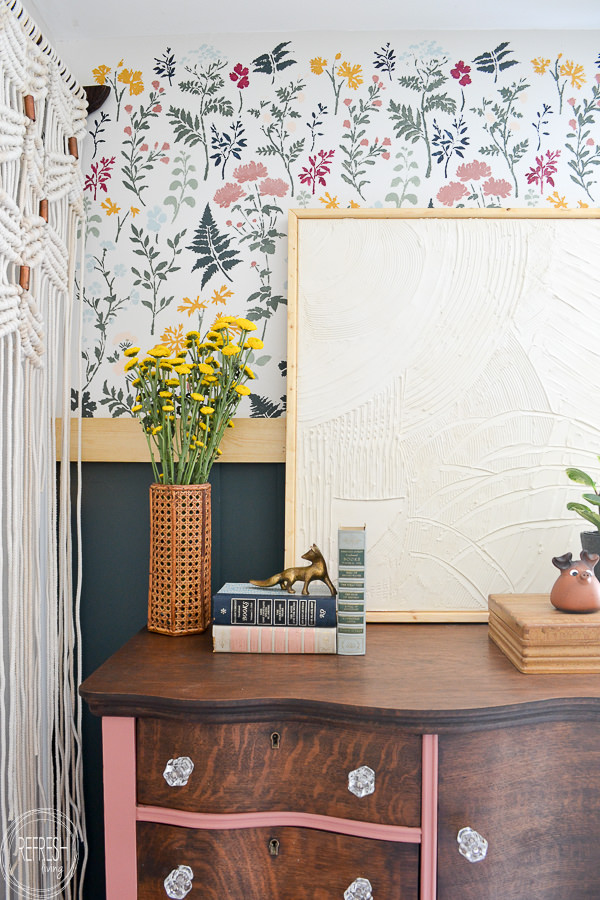 Bedroom makeover full of DIY and budget friendly projects. DIY loft bed, modern wainscot, refinished vintage furniture, and floral stencil to give the look of wallpaper.