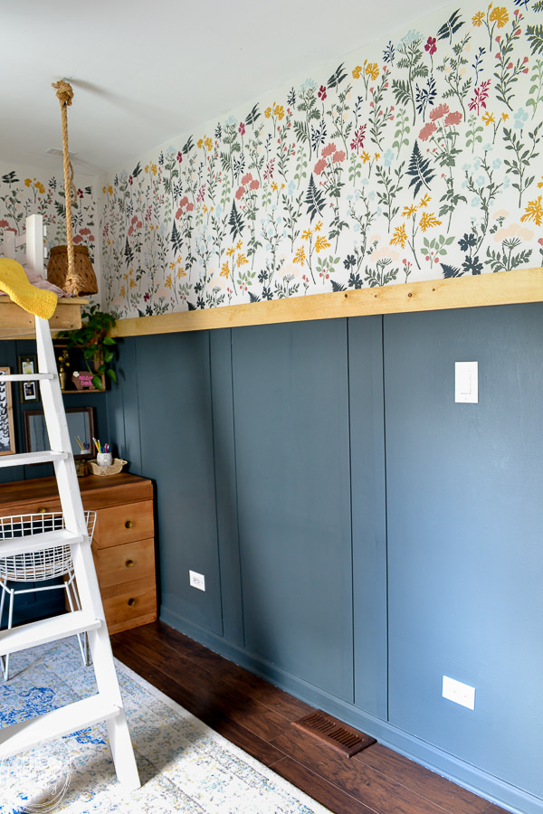 Bedroom makeover full of DIY and budget friendly projects. DIY loft bed, modern wainscot, refinished vintage furniture, and floral stencil to give the look of wallpaper.