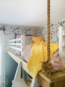 Bedroom makeover full of DIY and budget friendly projects. DIY loft bed, modern wainscot, refinished vintage furniture, and floral stencil to give the look of wallpaper.