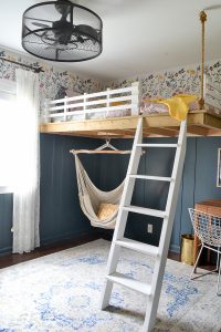 Bedroom makeover full of DIY and budget friendly projects. DIY loft bed, modern wainscot, refinished vintage furniture, and floral stencil to give the look of wallpaper.