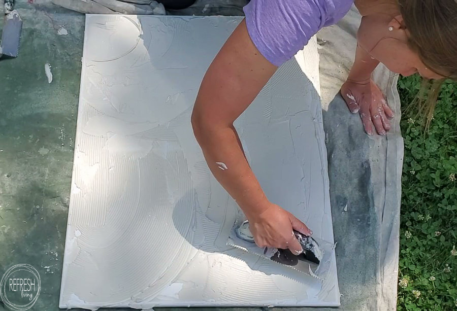 Such an easy way to make large scale art for cheap using canvas artwork and drywall mud. Video tutorial and step by step process for how to make a DIY modern art on canvas