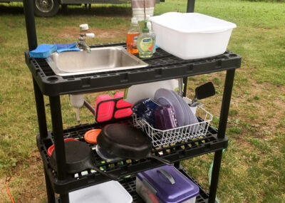 DIY camp kitchen made from plastic shelves and small sink and faucet