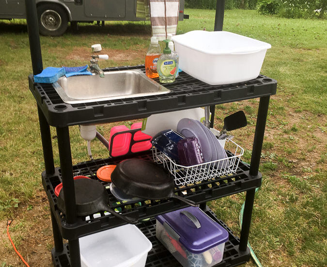 DIY camp kitchen made from plastic shelves and small sink and faucet