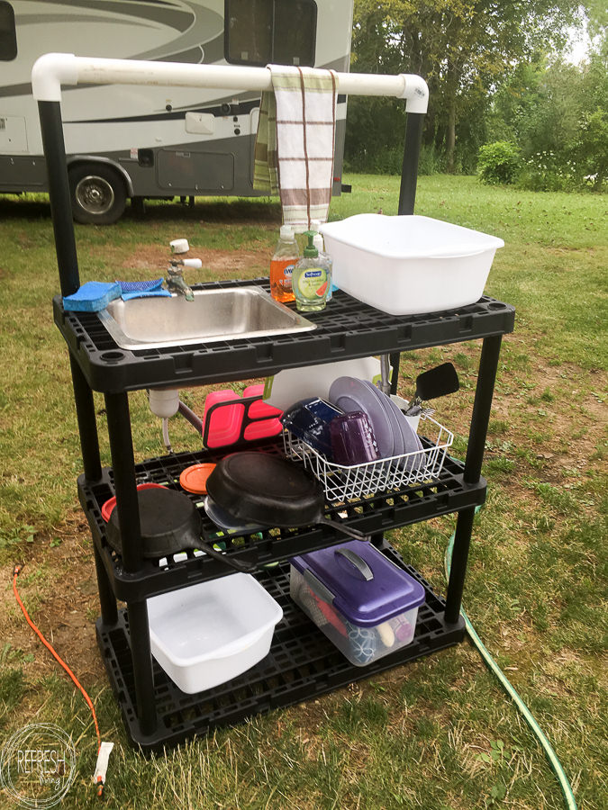 DIY camp kitchen made from plastic shelves and small sink and faucet 