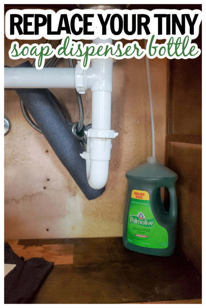 Kitchen with large bottle of dish soap under the cabinet with tube up to soap dispenser