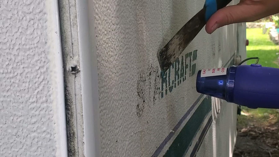 use a heat gun to remove decals on a camper before painting