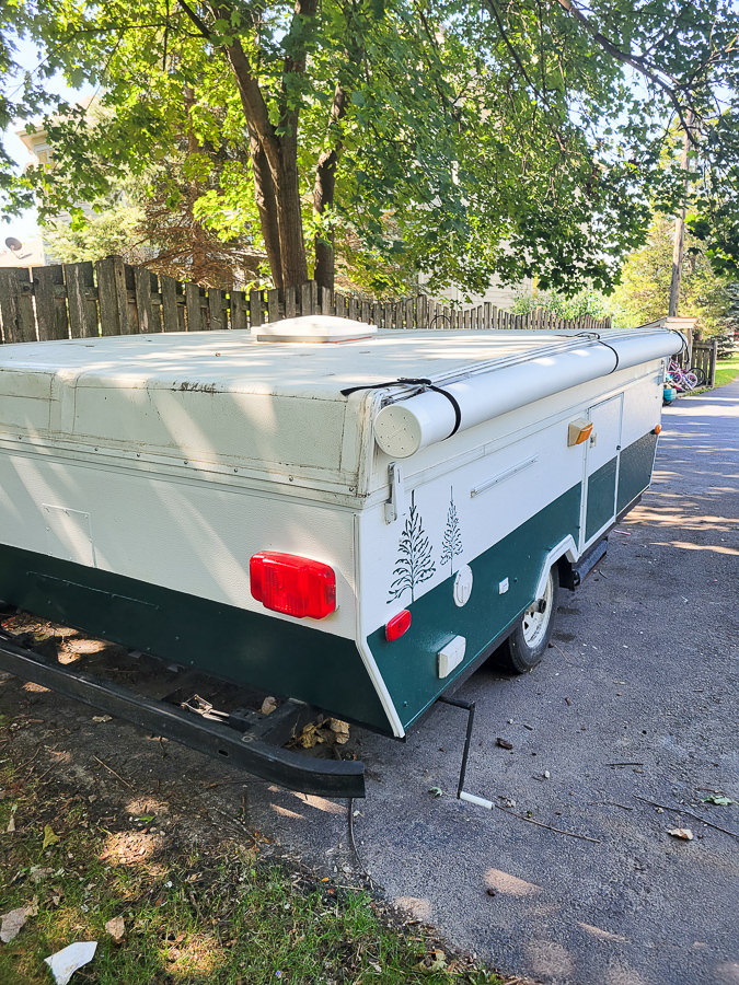 Green and white painted camper with tree stencils pop up camper remodel