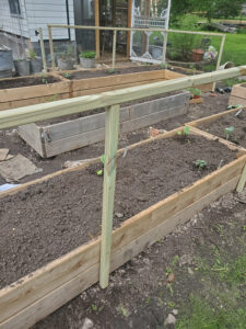 small fence attached to raised garden bed