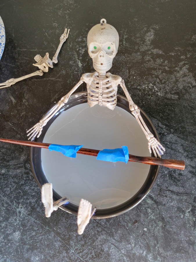 candle wax setting in a skeleton bath candle for halloween