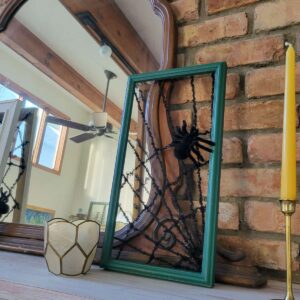 Halloween decoration made from picture frame into spider webs