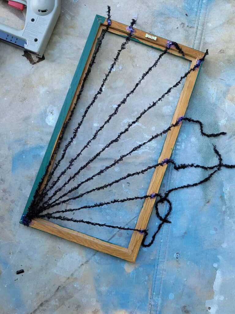 make a spider web decoration from an old picture frame thrift store