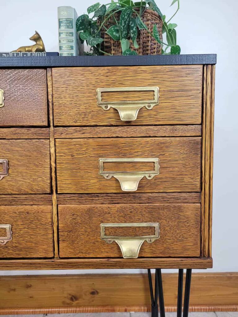 refinished vintage card catalog with natural quatersawn oak finish, hairpin legs, black top and brass label pulls