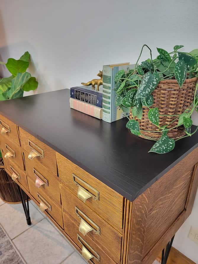 refinished vintage card catalog with natural quatersawn oak finish, hairpin legs, black top and brass bin pulls
