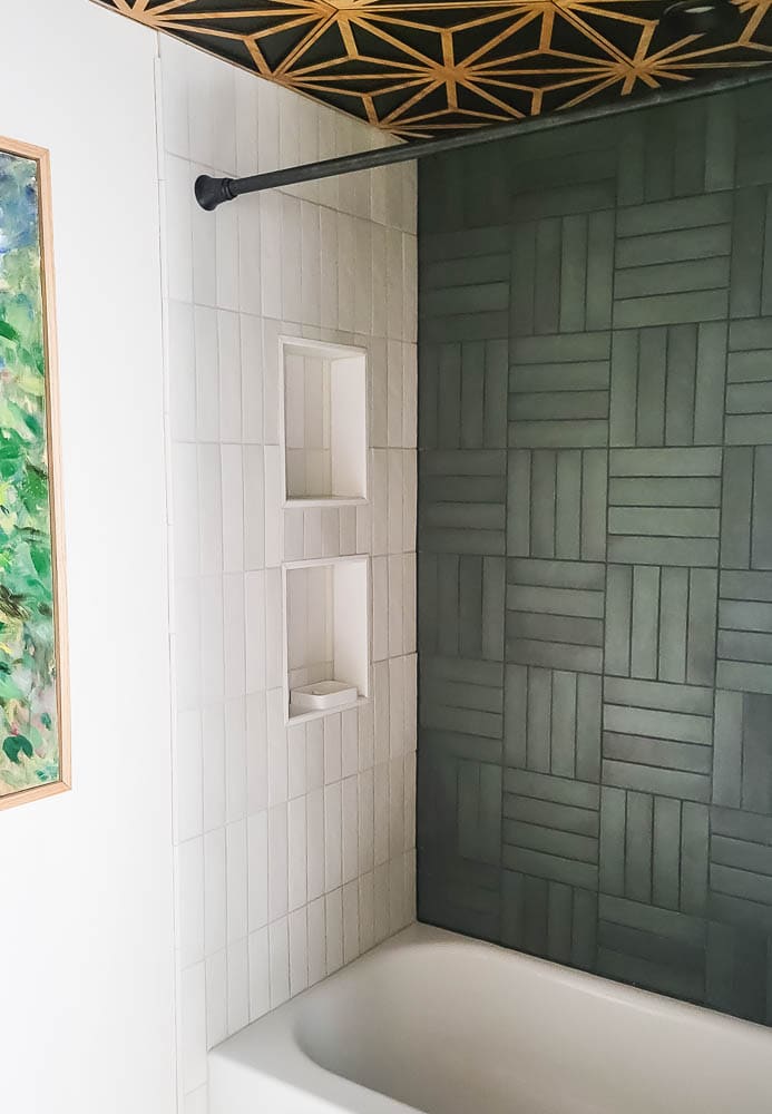 green tile in bathroom with basketweave pattern and white tile with vertical stack in shower